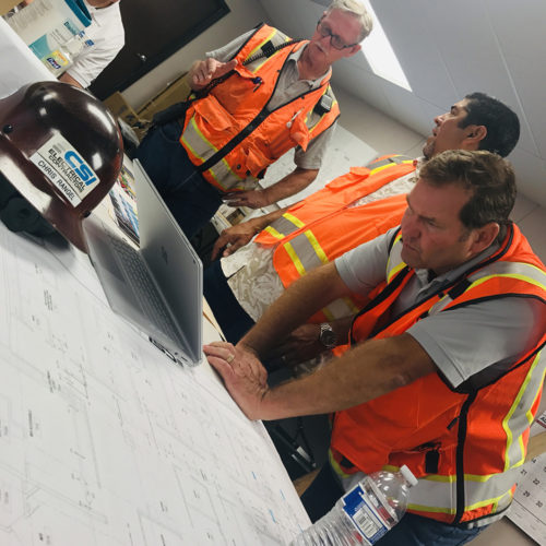 Group of technicians looking at a project plan